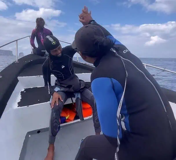 Group of divers preparing for Bali diving in Nusa Penida with clear blue skies.