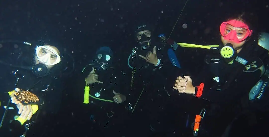 Group of divers exploring underwater in Nusa Penida, Bali.